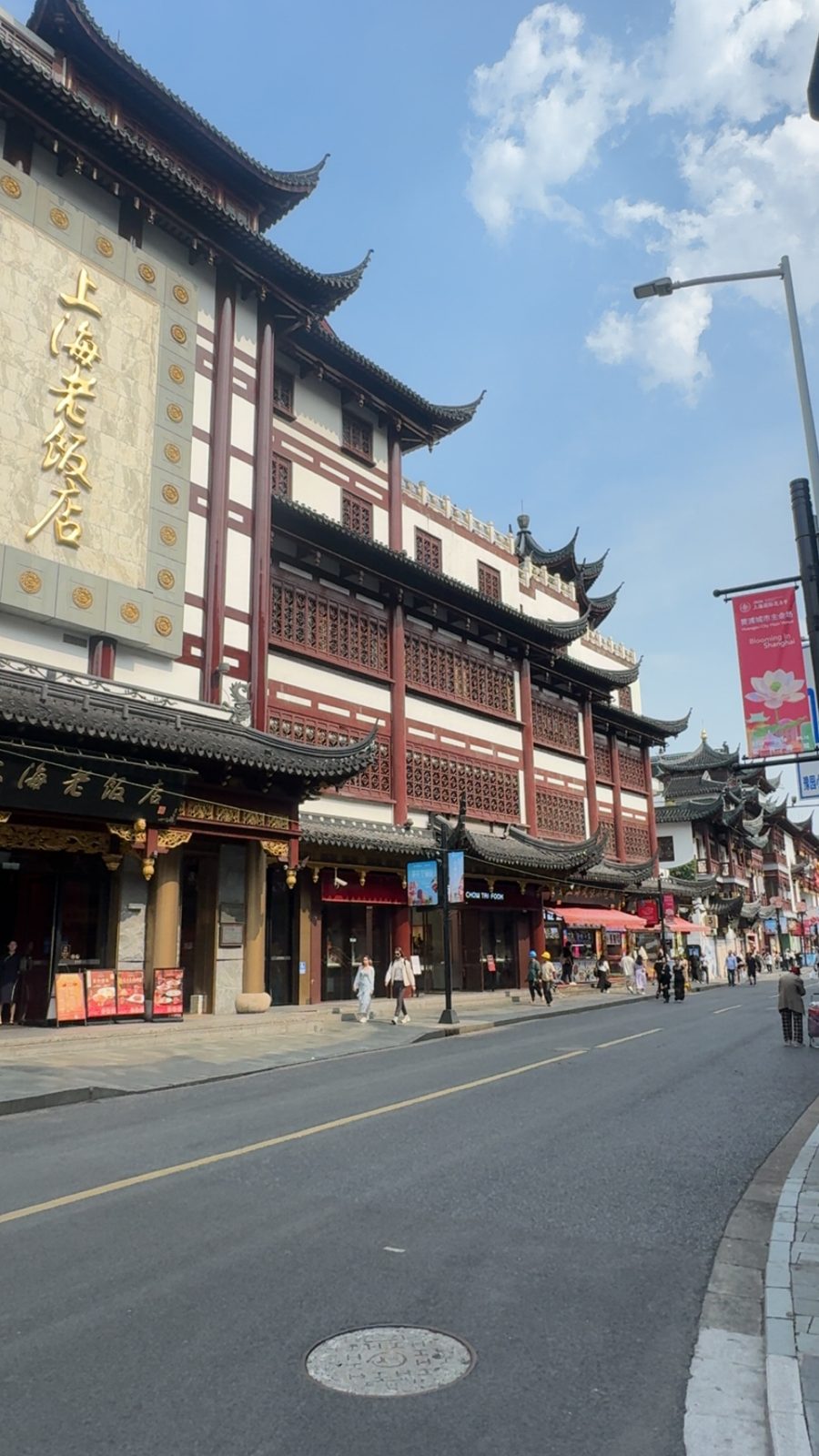 Traditional building with red lattice windows along a Shanghai street